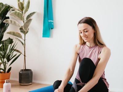 A neatly rolled yoga mat and a bottle of water.