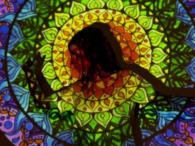 Silhouette of a person in a flowing yoga pose against a light background.